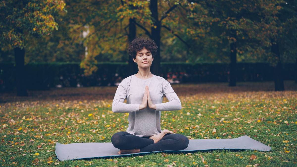 A beginner meditating peacefully on a cushion with a soft smile, illustrating meditation methods explained clearly for newcomers