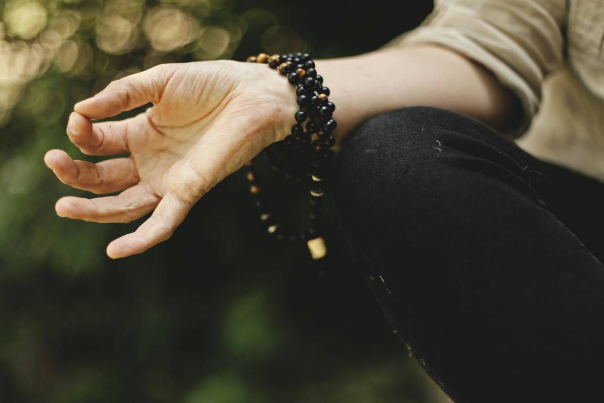 mindfulness explained: woman meditating peacefully on a cushion with soft morning light